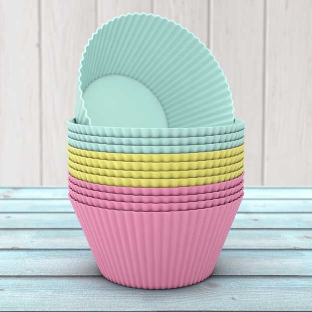 Anteil von bunten Cupcake-Silikon-Schalen auf einem Holztisch. 3D-Rendering