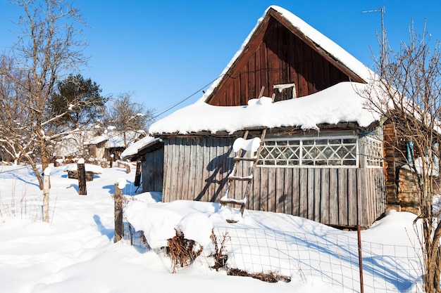 Antiga casa de campo russa em dia ensolarado de inverno