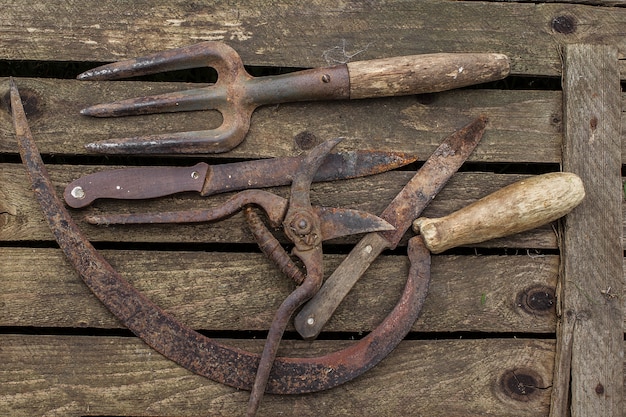 Antiga ferramenta de jardinagem em uma mesa rústica