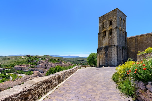 Antiga igreja românica com campanário e céu azul ensolarado