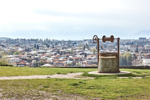 Foto antigo poço retro no fundo do panorama da cidade kutaisi georgia