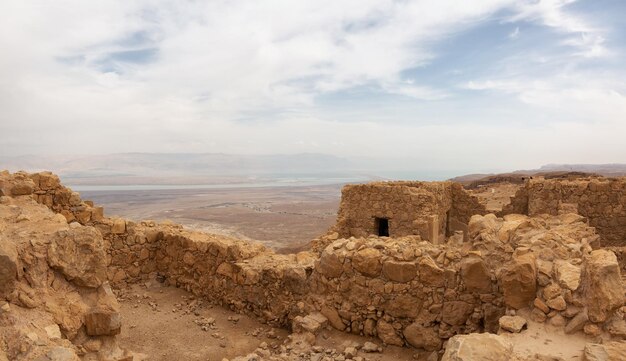 Antigua fortaleza en la cima de una montaña durante un día nublado y soleado