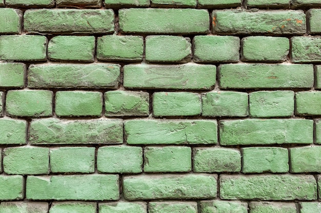 Antigua muralla de ladrillo verde, textura rústica