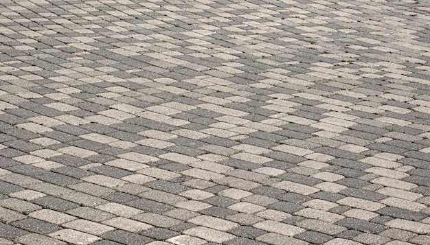 La antigua textura del pavimento de piedra gris de cerca