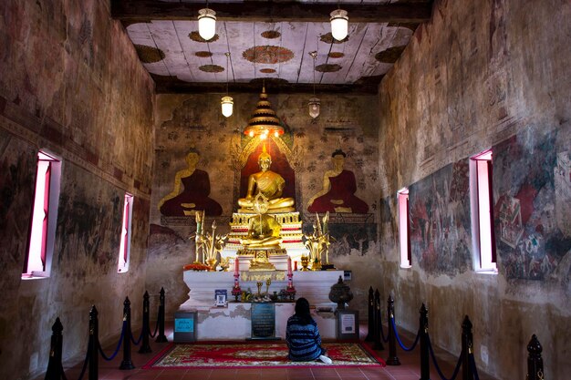 Antiguas estatuas de buda en la antigua iglesia de ubosot para los viajeros tailandeses que visitan y respetan la adoración sagrada de la bendición orante en Wat Chomphuwek o el templo Chumpoo Wek el 17 de marzo de 2022 en Nonthaburi Tailandia