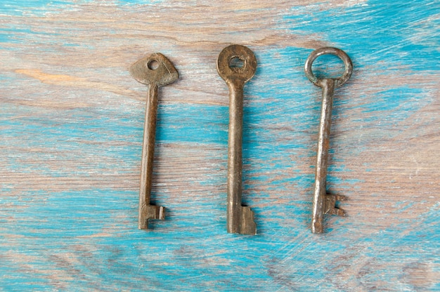 Antiguas llaves de hierro, detalle de un clásico de llaves metálicas sobre fondo de madera. Copiar espacio para texto