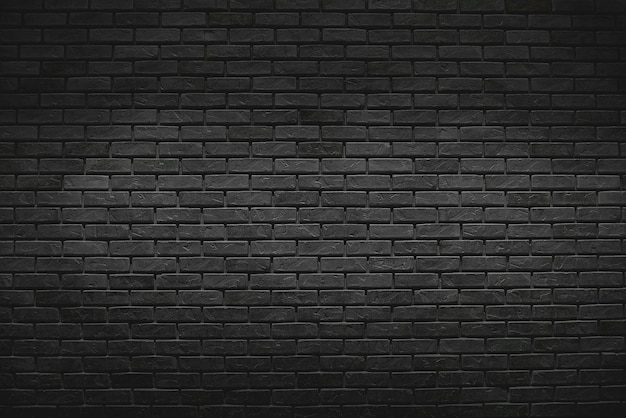 El antiguo fondo de la pared de ladrillo negro con luz de gradiente en la superficie