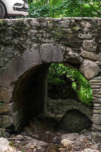 Un antiguo puente de arco turco arquitectónico hecho de piedra fue colocado en una zona montañosa