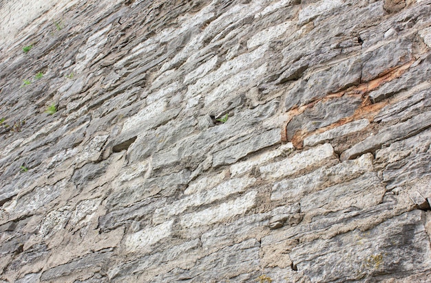 Antikes Mauerwerk. Alte Mauer aus Mauerwerk. Alte Felswand