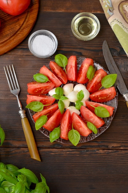 Antipasti-Caprese-Tomaten-Mozzarella und Basilikum auf der Tischansicht von oben