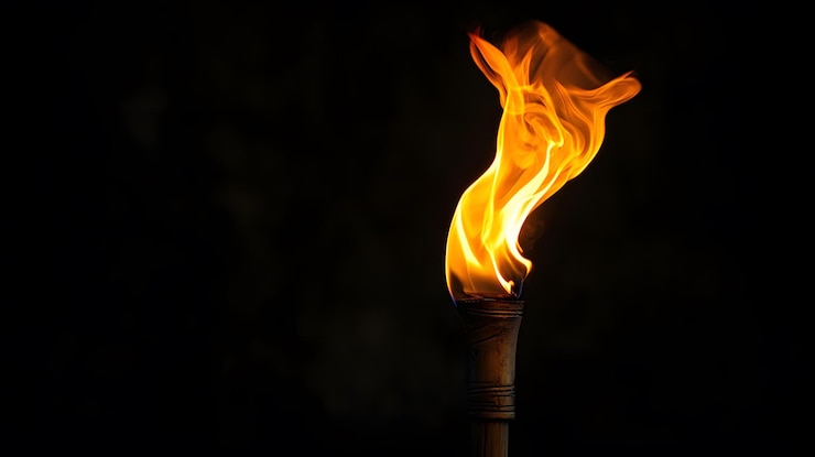 Foto una antorcha encendida contra un fondo negro