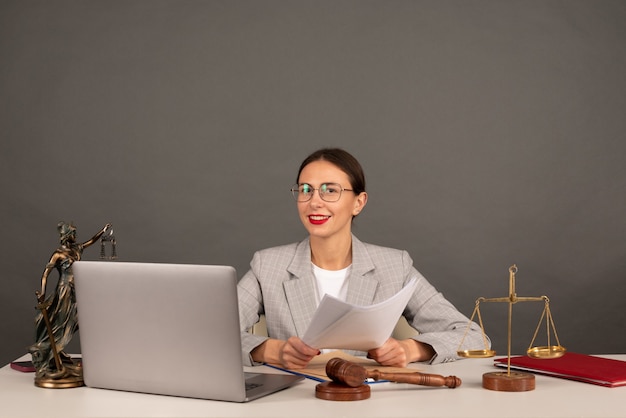 Anwaltsbüro. Gerechtigkeitsstatue mit Waage und Anwalt, die an einem Laptop arbeiten. Rechts-, Beratungs- und Justizkonzept