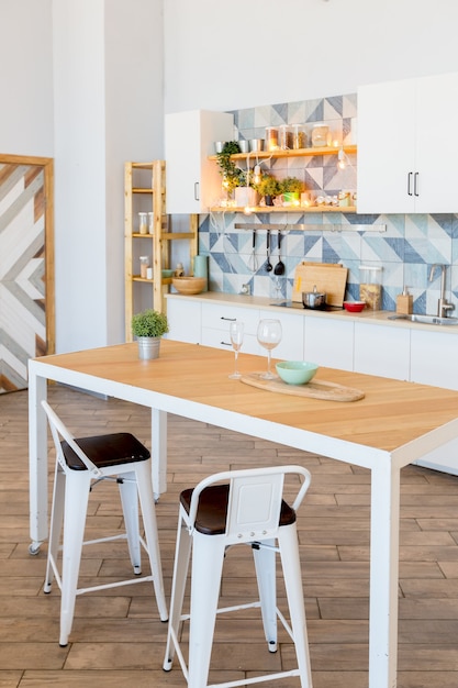 Apartamento espacioso de moda con un diseño elegante en colores pastel verde, gris y blanco con ventana grande y paredes decorativas. espacio de dormitorio y cocina