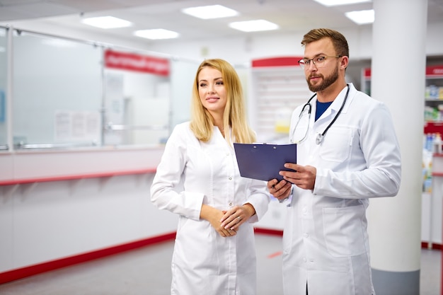 Apelando dois farmacêuticos caucasianos se comunicando