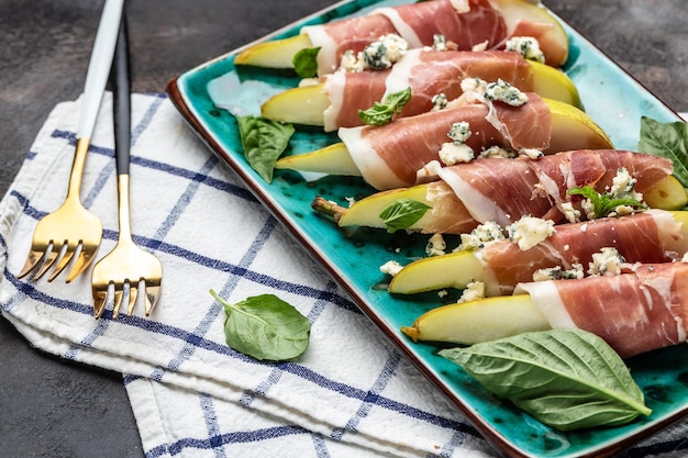 Aperitivo com pêra, queijo azul e presunto, gorduras saudáveis, alimentação limpa para perda de peso, vista superior em formato de banner longo