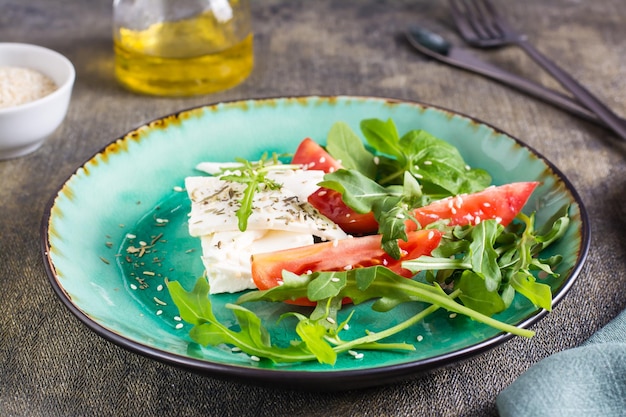 Aperitivo fresco de tomates queso feta y rúcula en un plato Dieta orgánica