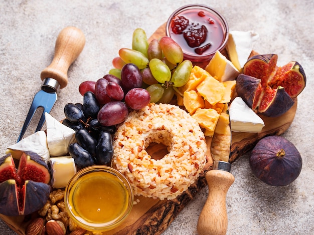 Aperitivo para vino, plato de queso con uvas e higos.