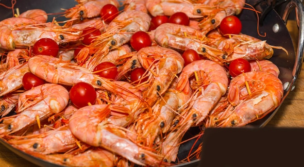 Apetitosos camarones cocidos con tomates en el festival de comida, concepto de alimentos y bebidas