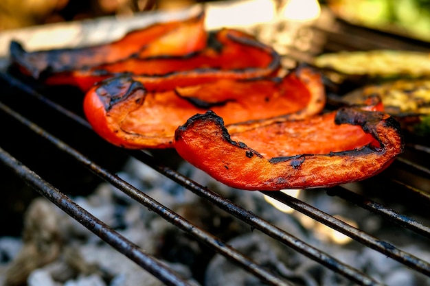 Apetitosos vegetales pimientos rojos preparados a la parrilla o barbacoa abierta. Comida sana vegetariana o vegana sabrosa caliente. De cerca. Al aire libre.