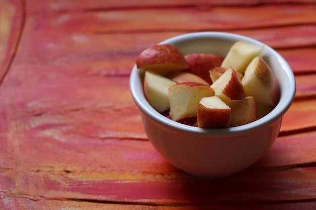 Apfel im Topf auf rotem Grund