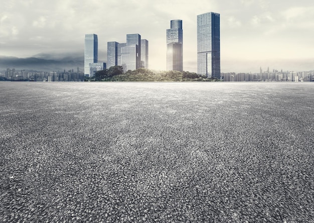 Apokalyptische Atmosphäre, unbemannter Asphaltplatz mit Panoramablick auf die Skyline der Stadt