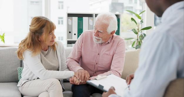 Apoyo de asesoramiento y pareja mayor con terapeuta en consulta para ayuda conversación o orientación de crisis Terapia depresión y personas mayores tomadas de la mano consultoría de matrimonio o experto en salud mental