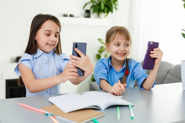 Aprendiendo desde casa, concepto de niño de escuela en casa. Los niños pequeños estudian el aprendizaje en línea desde casa con una computadora portátil. Concepto de cuarentena y distanciamiento social.