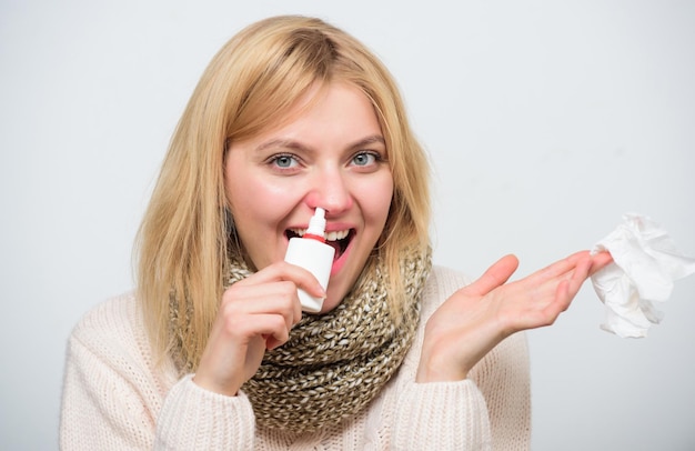 Apretar la bomba Niña poco saludable con secreción nasal usando aerosol nasal Linda mujer amamantando resfriado nasal o alergia Mujer enferma rociando medicamentos en la nariz Tratamiento de resfriado común o rinitis alérgica