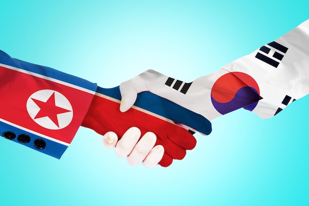 Apretón de manos entre la bandera de Corea del Norte y Corea del Sur