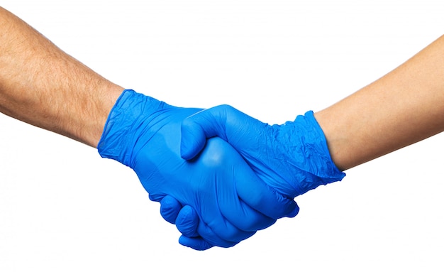 Apretón de manos en guantes azules, concepto de ayuda. Higiene personal durante una pandemia