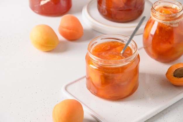 Aprikosenmarmelade im Glas mit Früchten Sommerernte und Konserven