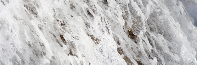 Aproximação da água borbulhante da cascata com fluxo de cascata de rio de montanha de espuma branca flui sobre