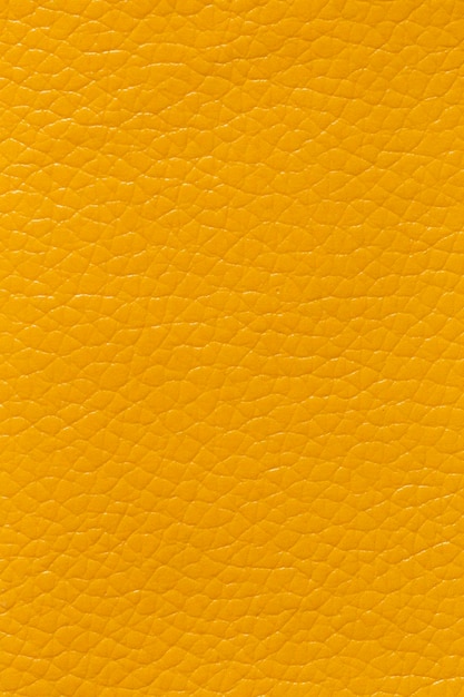 Aproximação de um couro amarelo e um plano de fundo texturizado
