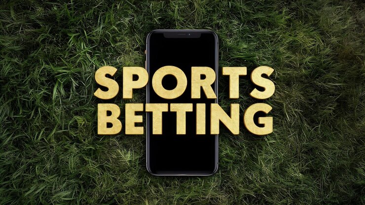 Foto las apuestas deportivas de inscripción dorada en un teléfono inteligente sobre un fondo de hierba verde