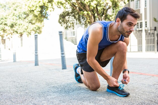 Apuesto atleta atar sus zapatos