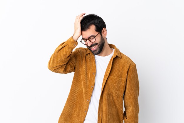 Apuesto hombre caucásico con barba con una chaqueta de pana sobre una pared blanca aislada se ha dado cuenta de algo y tiene la intención de la solución