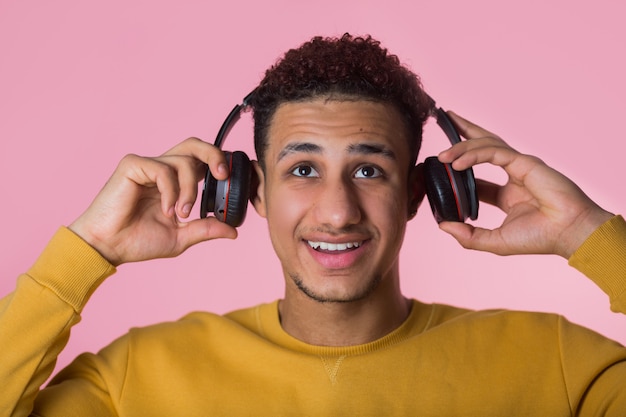 Foto apuesto joven africano usando audífonos