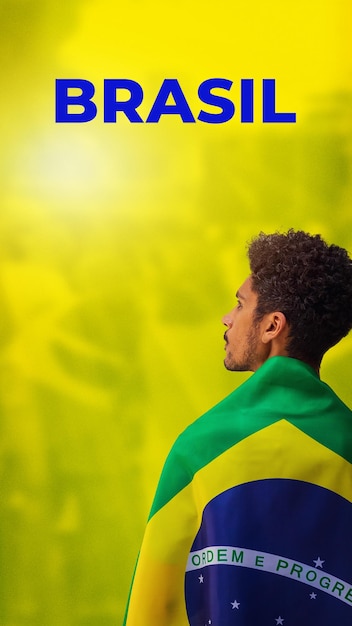 Apuesto joven negro jugador brasileño sosteniendo la bandera de Brasil en el fondo cinematográfico
