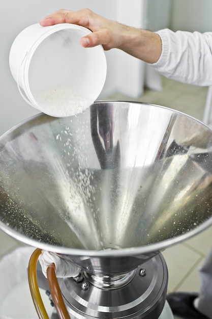 Arbeit schläft Kokosnusschips in einer industriellen Brecherpresse. Lebensmittelproduktion