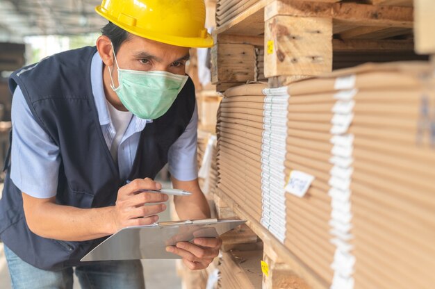 Arbeiter, der den Rohstoffbestand in der Fabrik überprüft