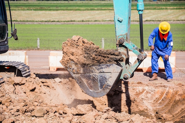 Arbeitsbagger-Traktor, der einen Graben graben.