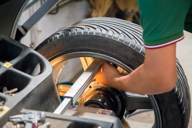 Arbeitskraft repariert ein Auto in einer Autoreparaturmitte