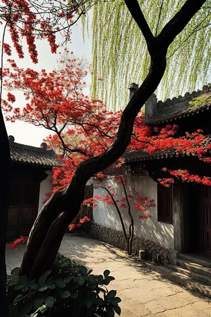 Un árbol con flores rojas frente a un edificio.