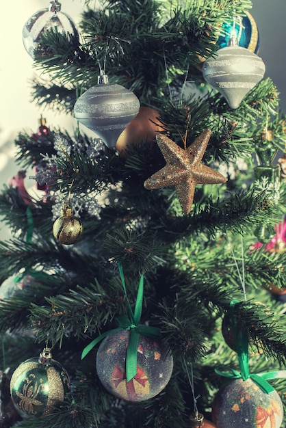 Foto Árbol de navidad decorado con adornos, adornos, burbujas, bolas y estrellas doradas.