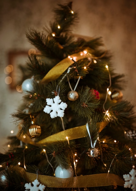 Foto Árbol de navidad decorado con adornos dorados y blancos.