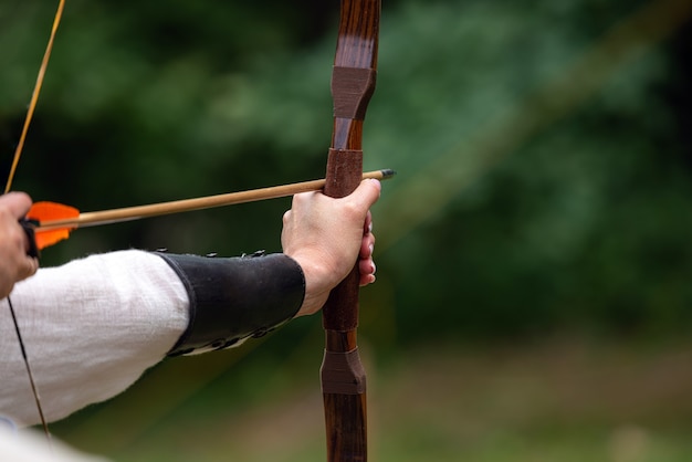 Archer hält seinen Bogen und zielt auf den Ziel-Bogenschießen-Wettbewerb.