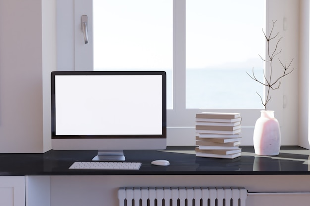 Área de trabalho do computador em branco com teclado na mesa e livros à janela na mesa de mármore em um quarto ensolarado