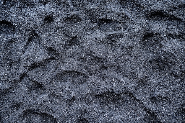 Areia preta como pano de fundo Foto para o projeto Pegadas na areia Texturas na natureza