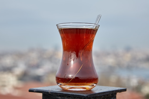 Armudu mit türkischem Tee steht auf dem Dachzaun mit unscharfem Blick auf Istanbul