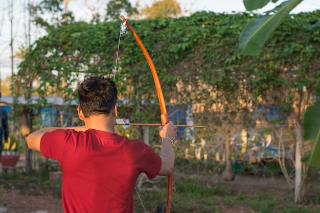 Foto arqueiro de homem mira em um alvo